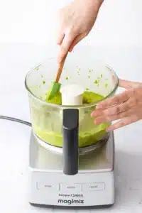 Thick pistachio paste on bowl sides during pistachio butter recipe