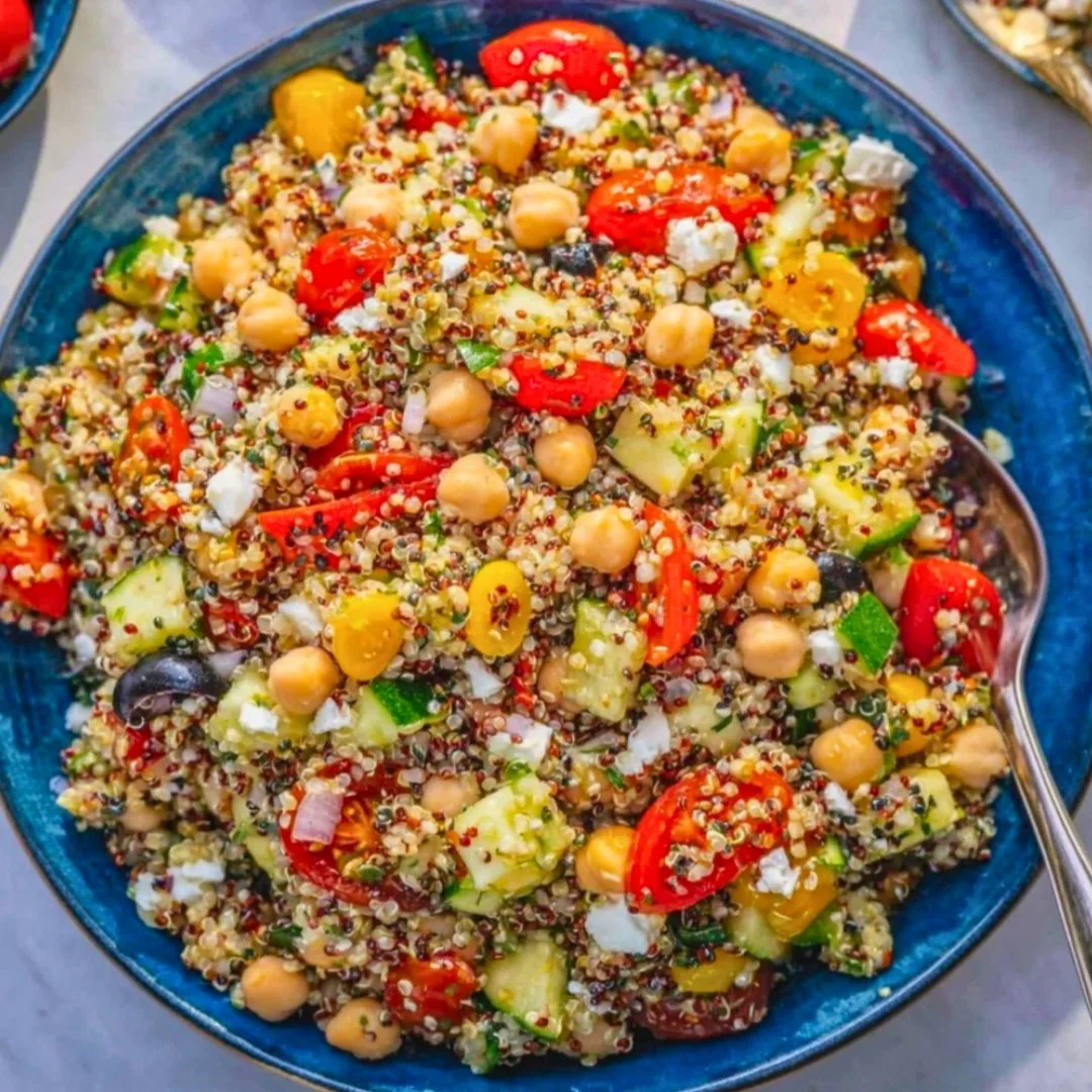Bowl of Greek Quinoa Salad with Chickpeas, tomatoes, and lemon dressing