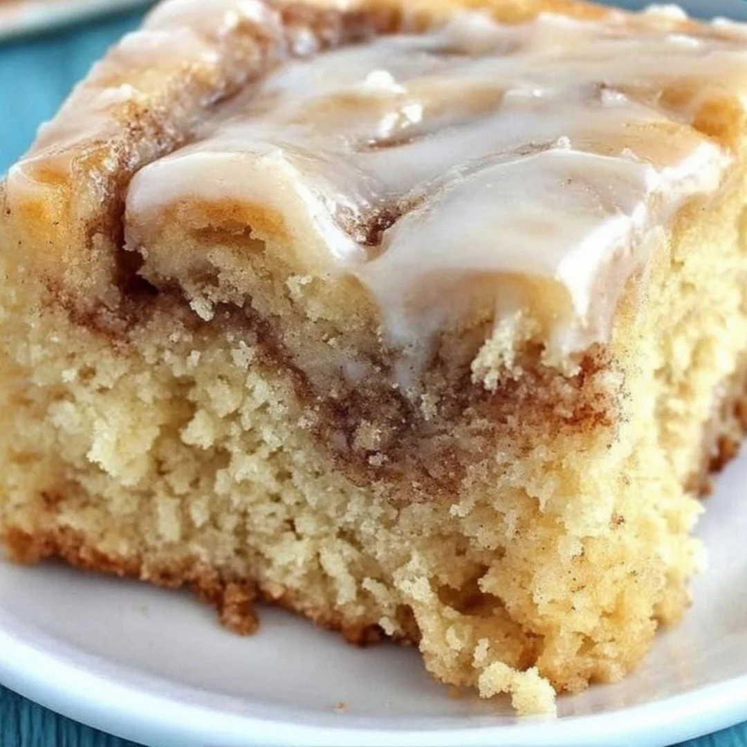 Homemade cinnamon roll cake with icing on a plate